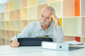 elderly man with thoughful face indoors