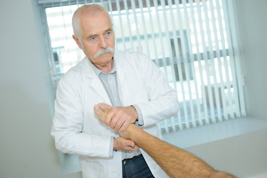 Medical worker manipulating patient's foot