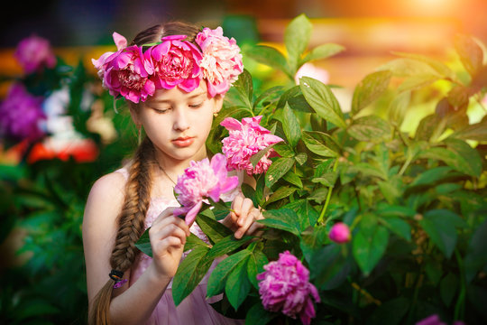  portrait of little girl outdoors with peony