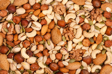 Mix of different nuts as background close-up - obrazy, fototapety, plakaty