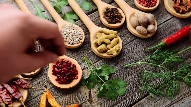 Different spices and fresh herbs on a wooden table