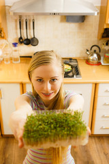 Happy woman holding cuckooflower cress