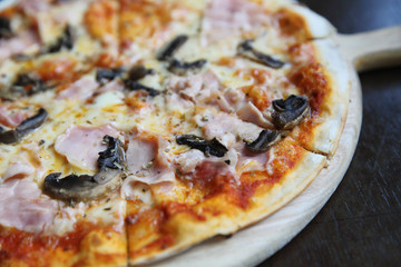 pizza ham and mushroom on wood