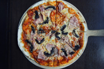 pizza ham and mushroom on wood