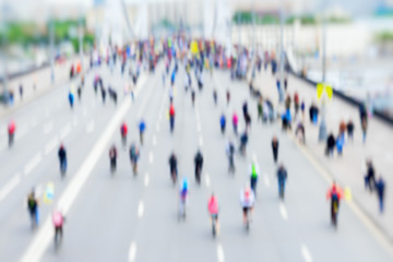 Abstract background of colored group of bicyclists in city center, bike marathon, blur effect, unrecognizable faces. Sport, fitness and healthy lifestyle concept.