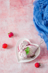 Homemade Strawberry ice cream in bowl shape heart on stone background. Top view