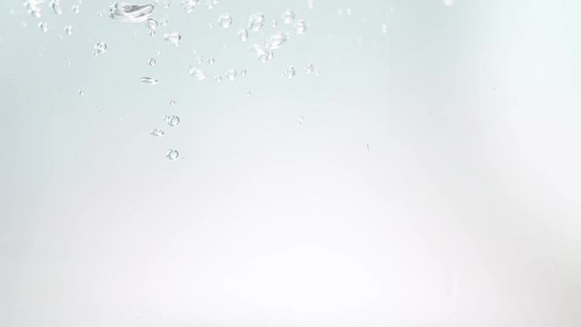fresh bubbles splash falling down into water, shot in slow motion on white background, purity and clean, nutrition and health care concept