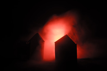 Old house with a Ghost in the moonlit night or Abandoned Haunted Horror House in fog. Old mystic villa with surreal big full moon. Horror concept.