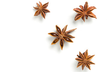 Star anise, scattered in a chaotic manner, isolated on white background