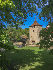 Fototapeta na wymiar Medieval Tower and City Wall in Germany Framed by Treelimbs