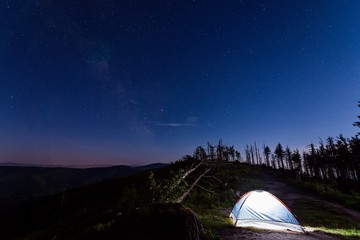 Fototapeta na wymiar Alone illuminated tent at night in Polish mountains