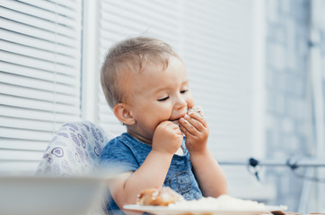 Fototapeta premium The child eats Lunch,meat chicken