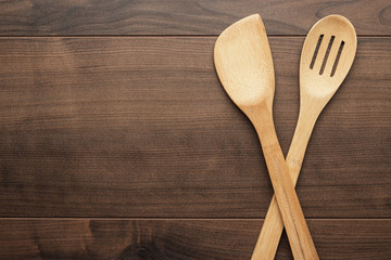 wooden skimmer and spatula, kitchen tools on the table with copy space