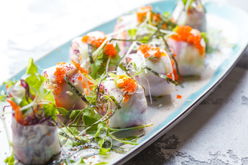 Vegetable rolls in rice paper with caviar. Healthy fitness food concept.