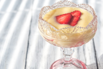 Sabayon with strawberry slices on the wooden background