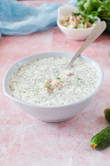 Okroshka. Summer light cold yogurt soup with cucumber, radish, eggs and dill on a table. A traditional dish of Russian and Ukrainian cuisine. Selective focus
