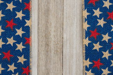 Red and blue stars burlap ribbon on weathered wood background