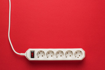European 5-way power strip earthed on red background