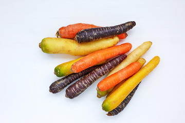 Organic food. Colorful carrots  on white wooden background. Top view, copy space.