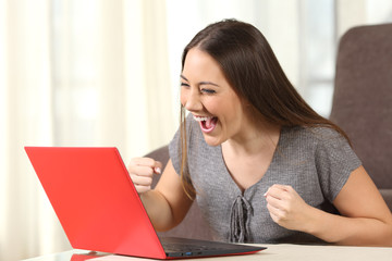 Excited woman reading good news on line