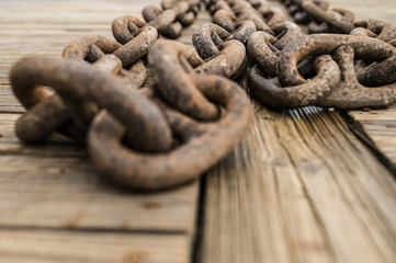 Ships anchor chain on a wooden pier in the harbor. Sardinia, Italy