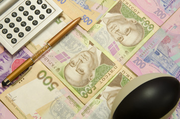 
Handle, calculator and antistress ball lie on Ukrainian money.