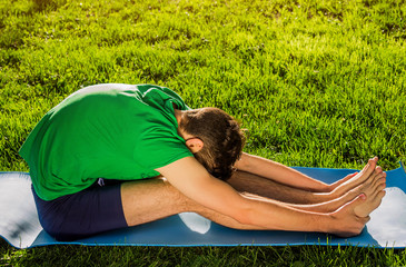 Seated forward bend pose. Practicing yoga