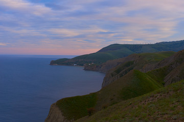 Fototapeta na wymiar Fantastic ocean landscape in sunset or sunrise time in summer with pink sky. Travel concept for Crimea. Hiking ways. Start of adventure time on to coast