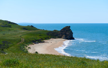 Wild bay with field road. Perfect place for hiking camping to the night. Little waves. Food surfing spot. Background for a extreme sports like windsurfing, diving, kiting, relaxing, meditation, yoga