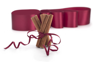 Cinnamon sticks tied with string on white background