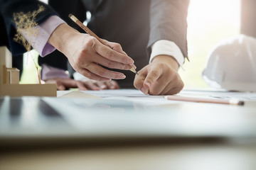 Image of engineer meeting for architectural project. working with partner and engineering tools on workplace