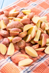 Sliced young potatoes drying on the kitchen dishcloth