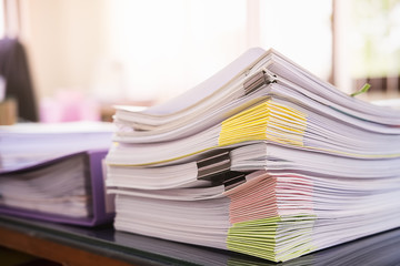Close up Pile of unfinished business documents on office desk, Stack of business paper.Select focus.