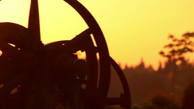 Rural landscape. Village house. Morning sunrise. Rural nature at morning sunrise. Bright sunlight in village courtyard. Close up old wheel cart in rural country at sun rise
