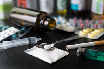 Pharmaceutical medicament, cure in container for health Drug syringe and cooked heroin on spoon.