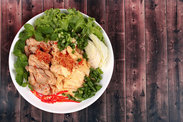 Spicy sour mixed vegetable salad with chicken and bamboo shoots.
