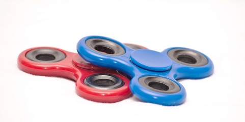 Blue and red fidget spinners with a white background