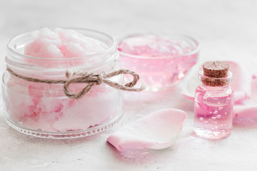 Obraz na płótnie Canvas homemade spa with rose cosmetic set, cream, salt and oil on white background