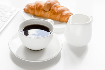 Businessman morning with cup of coffee and croissant on white table background