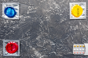 safe sex with condom contraception on dark background top view mock up