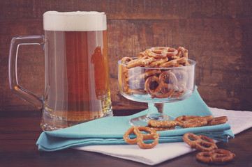 Glass of beer in stein with mini pretzels