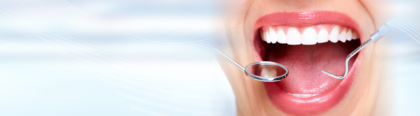 Woman teeth with dental instruments