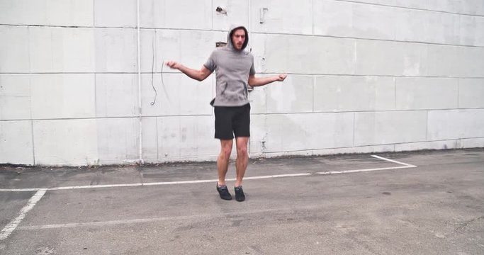 Athletic male working out in an empty parking lot. Crossfit. Slow Motion.