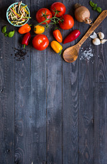 Delicious pasta with fresh vegetables and cheese, on a wooden background .