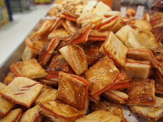 heap of puff pastry cookies in on shelf in bakery or baker's shop