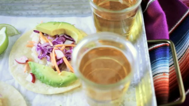 Fresh fish tacos with cod and purple cabbage on a white corn tortillas