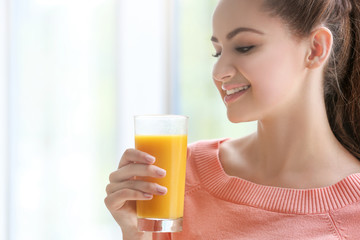 Young beautiful  woman with glass of juice