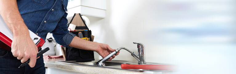 Plumber hands and water tap