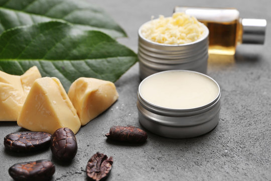 Beautiful composition with ingredients for cocoa butter lotion on table