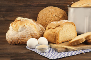 Different bread and ingredients on wooden table